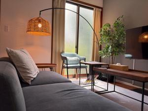 a living room with a couch and a table at Hook House Stay Kanazawa in Kanazawa