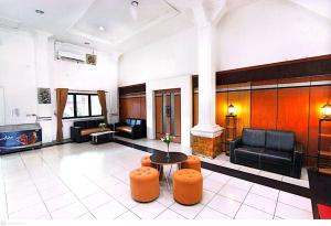 a living room with a couch and a table at Yasminstar Hotel in Muntok
