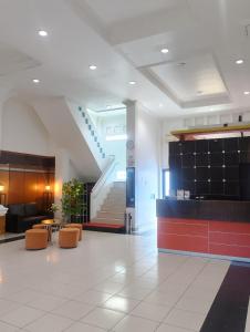 a lobby with a staircase in a building at Yasminstar Hotel in Muntok