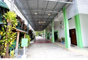 a hallway of a building with green and white at Yasminstar Hotel in Muntok