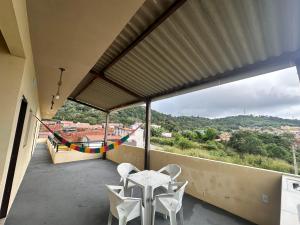 a balcony with a table and chairs and a view at Visão do Céu in Viçosa do Ceará