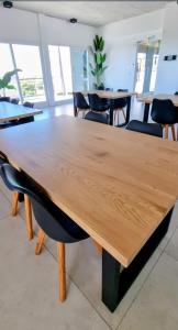 a large wooden table in a room with chairs at Tigre a estrenar in Tigre