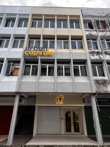 a building with a sign on the front of it at Urban Capsule by Faradale in Kuching