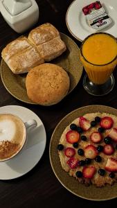 a table with plates of bread and a fruit pizza at Eco Bunnu Inn Santa Ana in Cusco