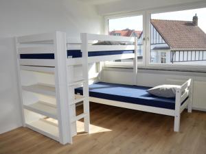 a bedroom with a bunk bed and a window at Villa Tamarisk - + box in Middelkerke