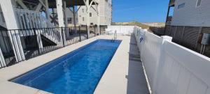 a swimming pool on a balcony of a house at Genesis On The Water - Semi-Oceanfront - Hot Tub - Pool in Rodanthe