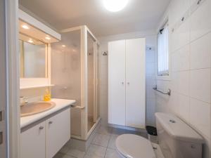 a white bathroom with a sink and a toilet at Westenwind - Nr. 3 + park. in Middelkerke +12 photos