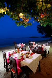 a table with plates of food sitting on a beach at Smile House - Fisherman Village in Bophut