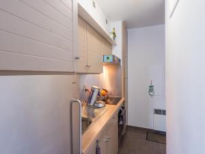 a small kitchen with a sink and a refrigerator at Nautilus - 0301 in Westende-Bad