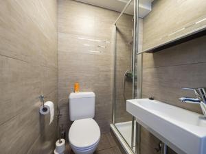a bathroom with a toilet and a sink at Nautilus - 0301 in Westende-Bad