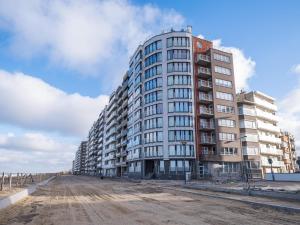 a tall building on the side of a dirt road at Nautilus - 0301 in Westende-Bad