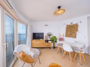 a living room with a white table and chairs at Nautilus - 0301 in Westende-Bad