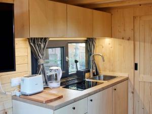 a kitchen with a sink and a mixer on a counter at Sugar Hut by Tiny Away in Great Horkesley