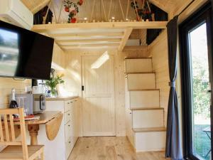 an interior view of a tiny house with a kitchen at Vilasini Hut by Tiny Away in Great Horkesley +5 photos