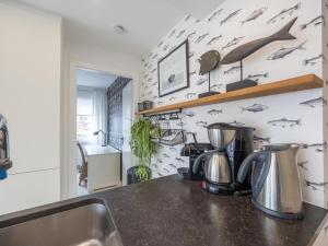 a kitchen with a sink and a counter top at Rising Sun - 0101 in Westende-Bad