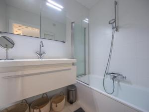 a white bathroom with a sink and a shower at Rising Sun - 0101 in Westende-Bad +8 photos