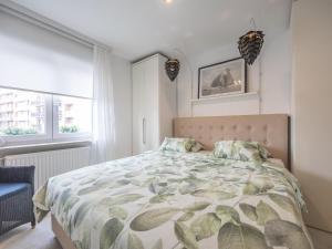 a bedroom with a bed with a leafy comforter at Rising Sun - 0101 in Westende-Bad