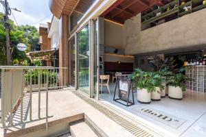 a house with glass doors and plants on a patio at BoH Collection in Medellín
