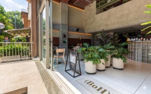 a restaurant with plants in pots on a patio at BoH Collection in Medellín +98 photos
