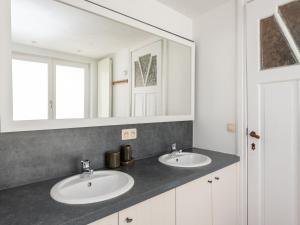 a bathroom with two sinks and a mirror at Notre Dame in Nieuwpoort +15 photos