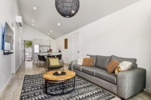 a living room with a couch and a table at Roam Taupo Lakefront Combined Units 1&2 in Taupo