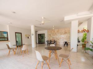 a living room with tables and chairs and a fireplace at Prukpibul Apartment in Bangkok