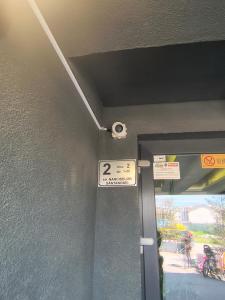 a door with a sign on the side of a building at Sunny Apartment in Oradea