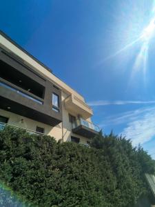 a building on a hill with the sun in the sky at Sunny Apartment in Oradea