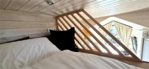 a small room with two beds and a window at Il Nostro Sogno - Madonna by Tiny Away in San Michele Salentino +7 photos