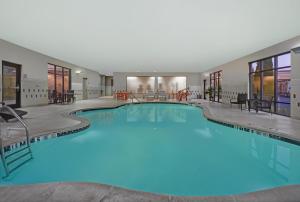 a large swimming pool in a hotel with blue lighting at Hampton Inn and Suites Robbinsville in Robbinsville