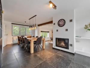 a dining room with a table and a fireplace at Landhuis Brakelbos in Brakel +47 photos