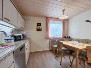 a kitchen and dining room with a wooden table at Vogel in Pirna