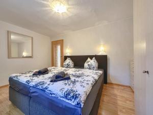 a bedroom with a bed with blue sheets and a mirror at Vogel in Pirna +25 photos