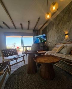 a living room with two tables and a couch at למרגלות הגלבוע in Gid‘ona