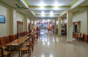 a hallway with tables and chairs in a building at Midtown homestay in Phong Nha