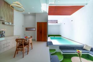 a kitchen and living room with a pool in the middle at Ghania Villas Melasti in Ungasan