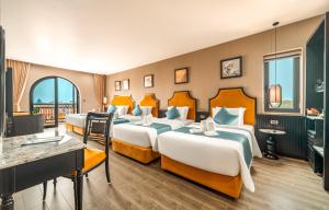 a hotel room with three beds and a television at Dream Future VangVieng Hotel in Vang Vieng +87 photos