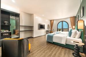 a hotel room with a bed and a large window at Dream Future VangVieng Hotel in Vang Vieng