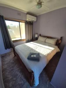 a bedroom with a bed with a tray on it at Yarrawonga Holiday House with Open Fireplace in Yarrawonga