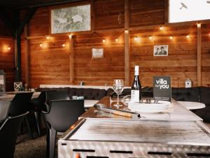 a dining room with a table with a bottle of wine at Friedensthal in Bad Pyrmont
