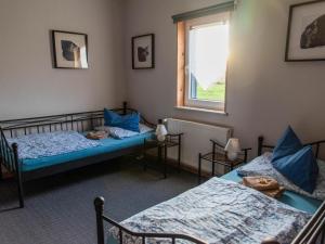 a room with two beds and a window at Brocken-Blick in Hüttenrode
