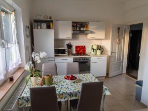 a kitchen with a table with a bowl of fruit on it at Brocken-Blick in Hüttenrode