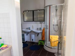 a bathroom with two sinks and a shower at Brocken-Blick in Hüttenrode +50 photos