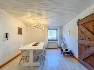 a dining room with a table and a barn door at Burgen in Burgen