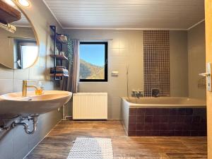 a bathroom with a sink and a bath tub at Burgen in Burgen +22 photos