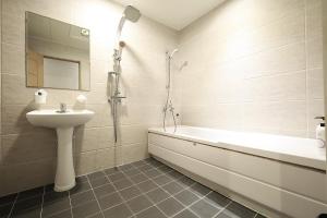 a bathroom with a sink and a toilet and a shower at Ingye Joy Hotel in Suwon +23 photos