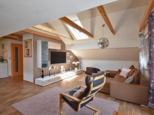 a living room with a couch and a tv at Gleißenberg in Gleißenberg