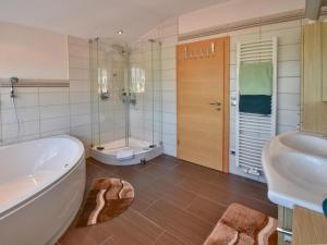 a bathroom with a tub and a sink and a toilet at Gleißenberg in Gleißenberg +16 photos