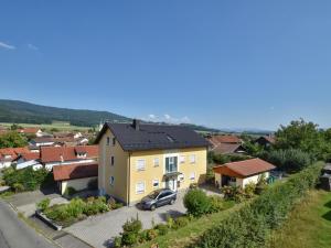 a yellow house with a car parked in front of it at Gleißenberg in Gleißenberg