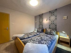 a bedroom with two beds in a room at Knusperhäuschen in Engenstein